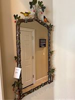 Full front view of mirror showing frame and mounted on wall