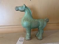 Side profile of green glazed horse figure
