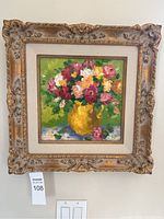 Full frontal view of the framed oil painting showing ornate wood frame and floral composition.