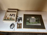 Full view of lot contents on white surface: original watercolour painting framed, wooden key box with keys, assorted skeleton keys, two small picture frames