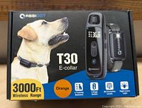 Box of RABBITBOT T30 E-collar showing dog image, product features like 3000 ft wireless range, 5 training sessions, 388 correction levels, night-vision light, and product branding
