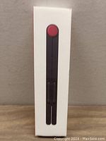 Front view of the boxed Genki Portable Kickstand showing product image.