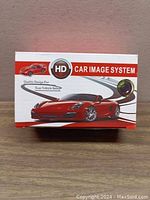 Box showing the branding and key selling points of the HD Car Image System with an image of a red sports car and the radar camera graphic.