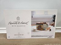 Front box view showing Hearth & Hand branding, product name Kids Bakery Set, image of assembled wooden bakery.