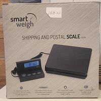 Photo of the Smart Weigh ACE110 shipping and postal scale box front showing scale image, branding, and basic features including large LCD display, durable platform, and expandable cord.