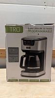 Boxed TRU programmable 12 cup coffee maker showing front and product image on box.
