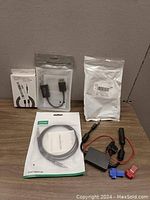 Photo of five packaged cables and connectors including Bingfu car stereo antenna adapter and IP audio charging cord.