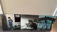 Front view of three Billy Joel vinyl album covers: 52nd Street, The Stranger, and Glass Houses placed side by side.