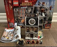 Complete LEGO Sanctum Sanctorum Showdown set 76108 with box, instruction manual, built set, mini figures and accessories displayed on a floor.