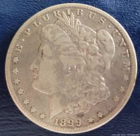 Obverse side of the 1899 Morgan silver dollar showing Lady Liberty and the year 1899.