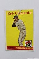 Front of card showing Roberto Clemente batting, card title and team name