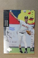 Front of 1994 Upper Deck Derek Jeter Rookie Card showing player in white pinstripe uniform throwing ball with team and series branding.