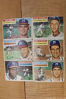 Front view of six 1956 Topps Milwaukee Braves baseball cards showing players Bob Buhl, Ernie Johnson, Chet Nichols, Danny O'Connell, George Crowe, and Johnny Logan in team uniforms.