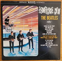 Front cover of the vinyl album "Something New" by The Beatles showing the band playing instruments with track list on the right side.