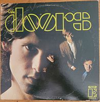 Front cover of The Doors 1967 self-titled vinyl album showing band members and logo.