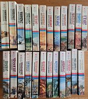 Spines of volumes 1 to 24 arranged in two rows with western scenes and color-coded design.