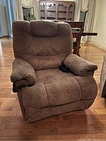 Front view of brown power recliner with attached remote