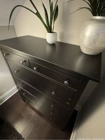 Full angled view of the black-brown IKEA HEMNES dresser showing top surface and drawers from above.