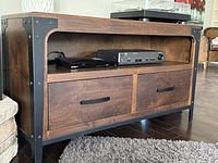 Front view showing open shelf with electronics and two drawers