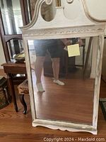 Full front view of the white washed antiqued wooden mirror showing the frame design and reflective surface.