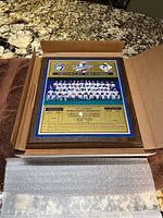 Plaque in original cardboard packaging showing full team photo and logos for Blue Jays and Braves along with World Series title.