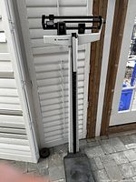 Full view of the Health-o-meter doctor scale showing the metal base, vertical height rod, and weight measurement beam.