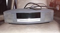 Front view of Bose Wave Music System showing digital display and CD slot.