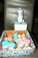 Box of 14 unopened Scentsy scented pods in various scents and colors packed together.