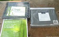 Lot showing 3 new bedding items: a bamboo sheet set from Comfy Bamboo Home, bamboo pillow protectors, and a Patrician sheet set in packaging.