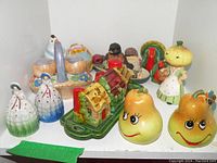 Overview of the collection featuring fruit-shaped, house, animal, and figure salt and pepper shakers arranged together