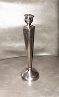 Single sterling silver candlestick shown upright with visible bent top part.