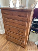 Juvenile sized 5-drawer wooden chest showing front and side profile.