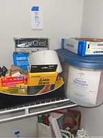 Wide view showing collection of orthopedic braces, gauze sponges, and medical tapes in storage bins and boxes