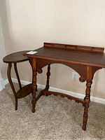 Two vintage wood accent tables: rectangular table with turned legs and decorative carved wood stretcher next to an oval table with curved legs and an under shelf.