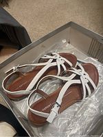 White braided strap sandals in a box