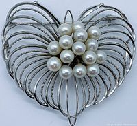 Front view of brooch showing sterling silver wire petals and clustered Akoya pearls center.