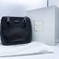 Bag positioned alongside branded box and dust cover bag.