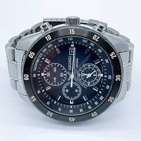 Front view of Seiko chronograph watch showing black dial with subdials and tachymeter bezel.
