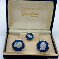 Front view of cufflinks and pin in original Wedgwood Stratton box, showing white cameos on blue background with gold-tone edges.