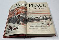 Open book showing illustrated title page of War and Peace by Leo Tolstoy, 1942 edition translated by Louise and Aylmer Maude with Foreword by Clifton Fadiman.