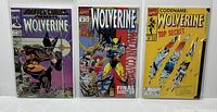 Full front view of the three Wolverine comics included in the lot, showing their covers and condition inside protective sleeves.