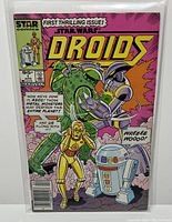 Front cover of Star Wars Droids #1 comic book in protective bag and board, showing main characters and vibrant colors.