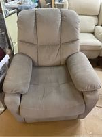 Front view of beige electric recliner in upright position
