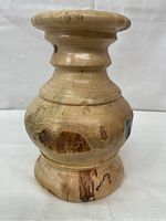 Front side view of the butternut wood vase showing rounded body and wood grain details
