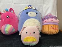 Front view of four Squishmallows plush toys showing each character and colors