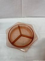 Top-down view showing the hexagon shape and three separate compartments of the pink glass dish bowl.
