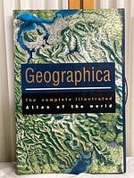 Geographica hardcover world atlas showing front cover with topographic design and title