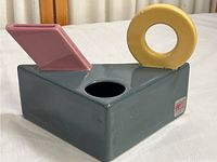 Side angle of the vintage Pelman Langer porcelain vase showing the rectangular base and abstract shapes