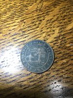 Reverse side of 1871 Prince Edward Island one cent coin showing coat of arms and denomination.