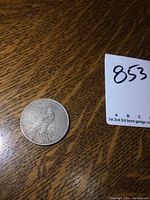 Obverse side of 1923 US Peace silver dollar coin showing eagle and inscriptions.